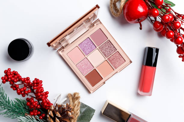 istock Set of professional elite decorative cosmetics for make-up on a white background with Christmas decorations. The concept of beauty and fashion. Fashion blog design. Top view. Flat lay 1203798878