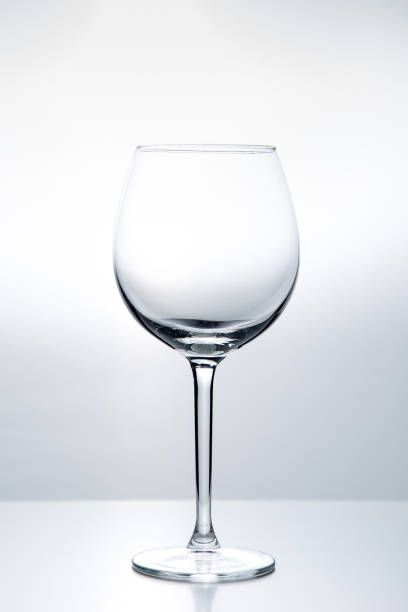 istock Elegant silhouette of an empty wine glass on a white background. Studio shot 1203799881