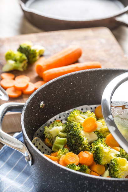istock Steamed mixed vegetable in black pot. Healthy vegetable concept 1203799942