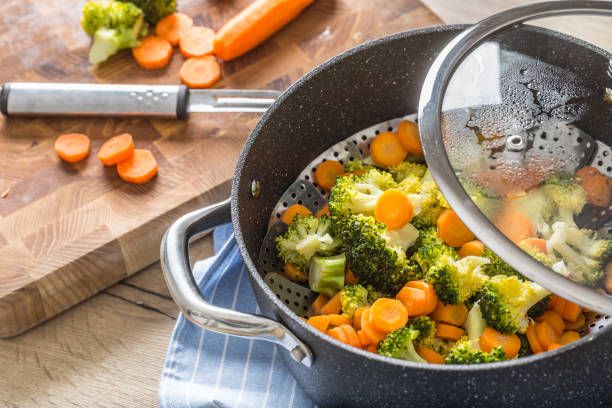istock Steamed mixed vegetable in black pot. Healthy vegetable concept 1203799943