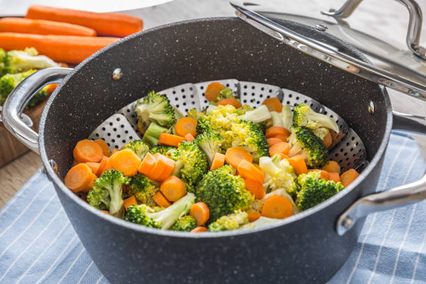 istock Steamed mixed vegetable in black pot. Healthy vegetable concept 1203799946