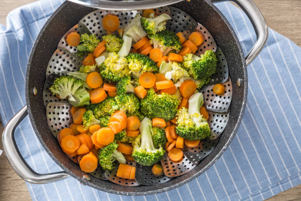 istock Steamed mixed vegetable in black pot. Healthy vegetable concept 1203799948