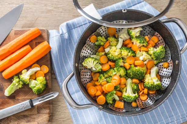Steamed mixed vegetable in black pot. Healthy vegetable concept