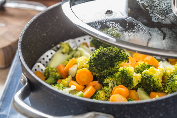 istock Steamed mixed vegetable in black pot. Healthy vegetable concept 1203799962