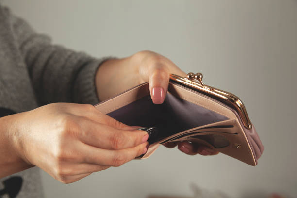 istock woman hand wallet with coins 1203800018