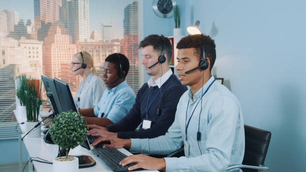 istock Multiracial call center agents talking to the clients in headset 1203800068