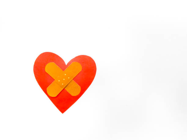istock Ill red heart shape with cross bandage on white background. 1203801996