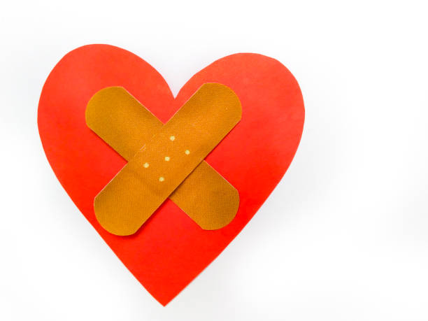 istock Ill red heart shape with cross bandage on white background. 1203802025