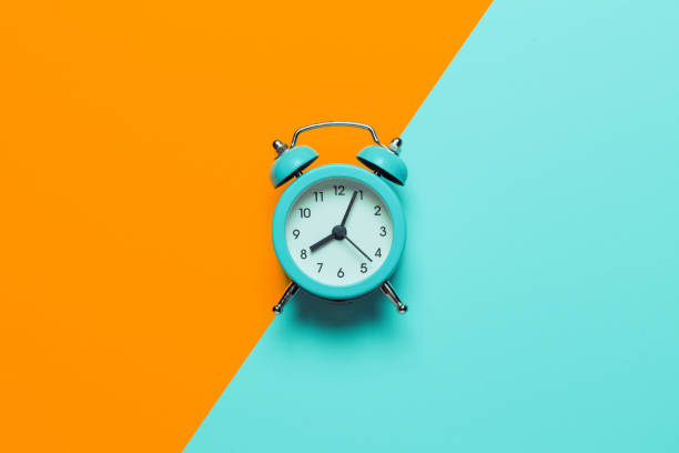 istock Punctual people concept, deadline in business. Analog alarm clock 1203802117