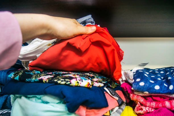istock Woman's Hands Selecting Clothes stock photo 1203803914
