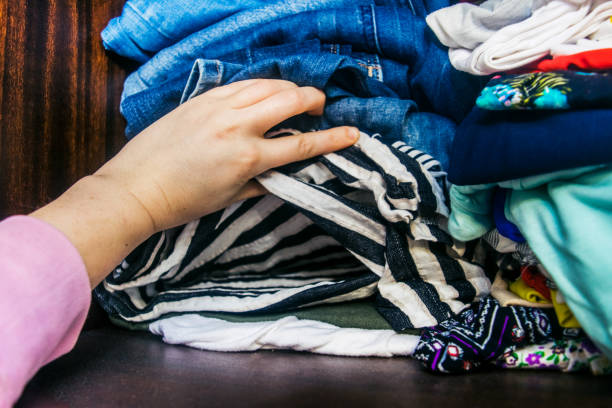 istock Woman's Hands Selecting Clothes stock photo 1203804245