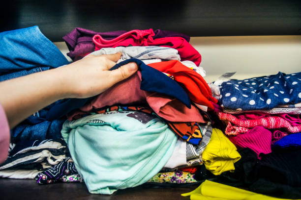 istock Woman's Hands Selecting Clothes stock photo 1203804900