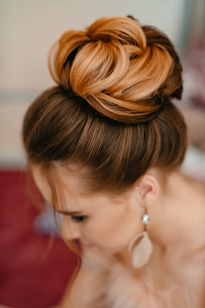Girl with haircut and make-up. Beautiful woman. Young girl with stylishh hair and bright make-p is going to prom. She enjoyes her youghth and beauty. Concept of professional stylist, womanhood and celebration. hair bun stock pictures, royalty-free photos & images