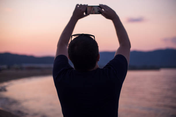 istock Tourist taking a selfie on a beach 1203805312