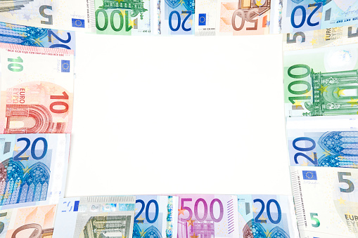 Various Euro bills in a frame composition on white background.