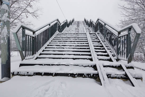 Old overpass over a railway line covered in snow. Russia.