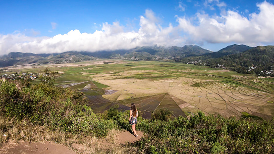 Ruteng - Una chica admirando los campos de arroz de tela de araña desde arriba photo