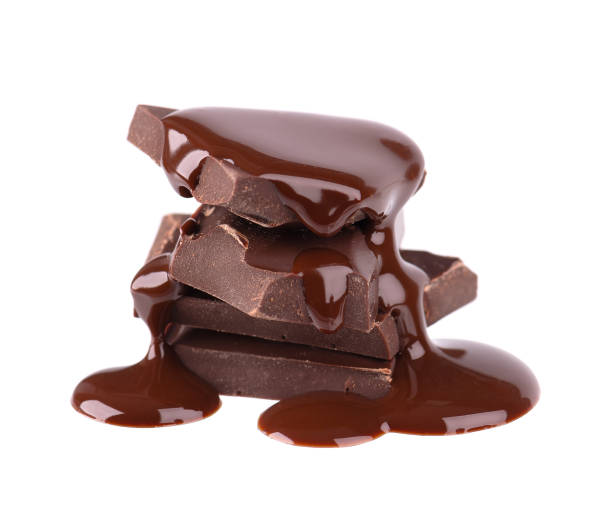 istock Chocolate pieces stack and chocolate syrup isolated on white background. Close up. 1203808516