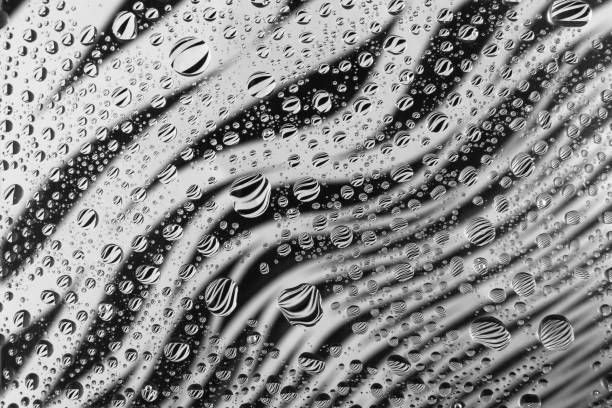 istock abstract water drop background on a beautiful black and white background with reflection 1203810181