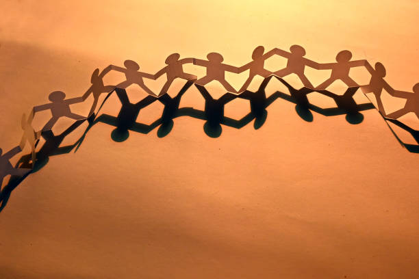 istock Silhouette paper in man shape hold hand together 1203810256