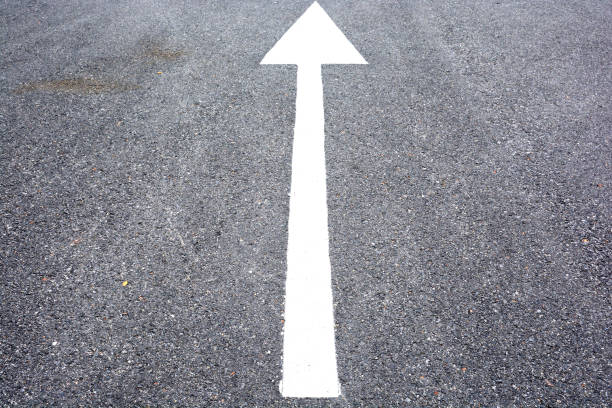 istock white arrow sign on the dry soil, ground, background 1203810295