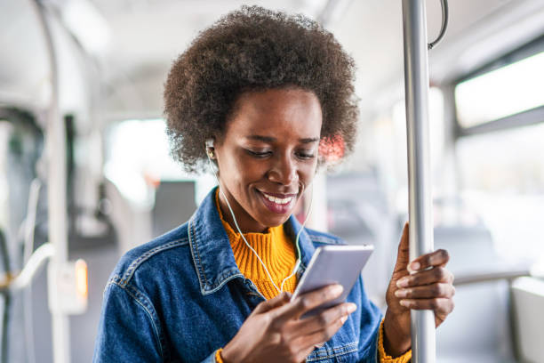 istock Young woman traveling by bus and using smart phone. 1203810564