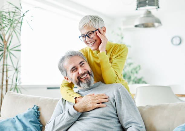 senior couple happy elderly love together portrait of happy smiling senior couple at home eastern european 50s mature women beauty stock pictures, royalty-free photos & images