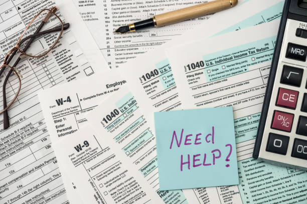 istock 1040 tax form in office with need help text 1203811855