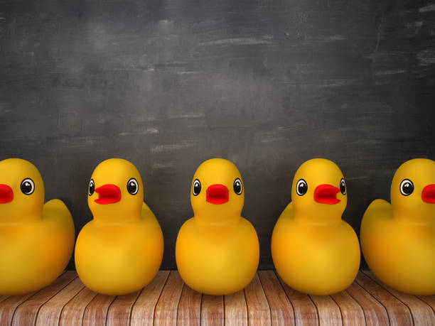 istock Rubber Duck on Wood Floor - Chalkboard Background - 3D Rendering 1203813172