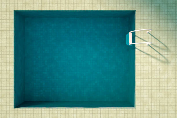 Background of swimming water in a pool with rain drops on the surface.
