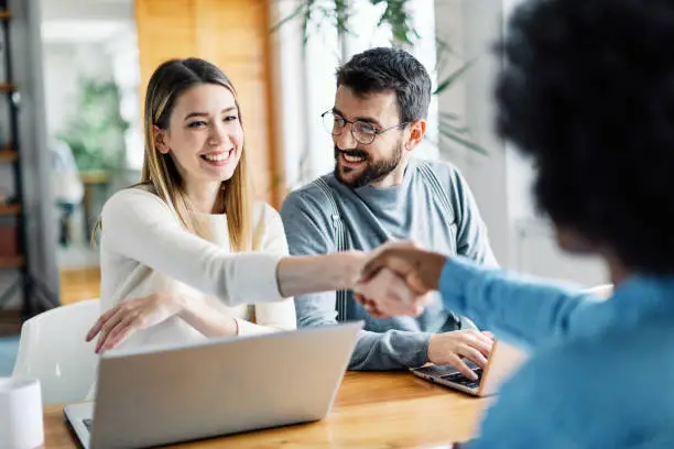 Photo of young couple shaking hands deal contract real estate investment