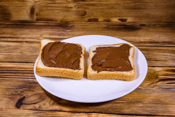 istock Two sandwiches with chocolate spread on a white plate 1203814934