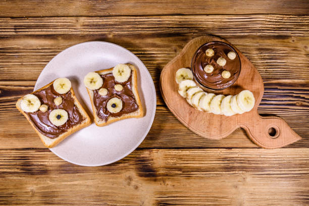istock Two sandwiches with chocolate spread on a plate. Sandwich like a bear muzzle. Top view 1203814958