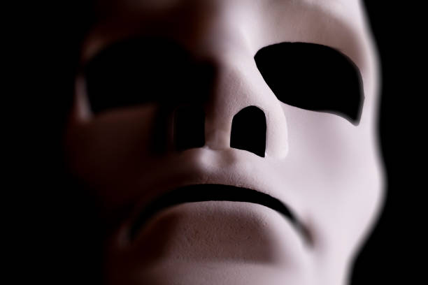 istock blank mask close up on black background 1203815184