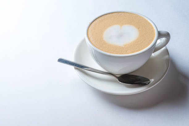 istock Cup of coffee with heart pattern in a white cup 1203815921