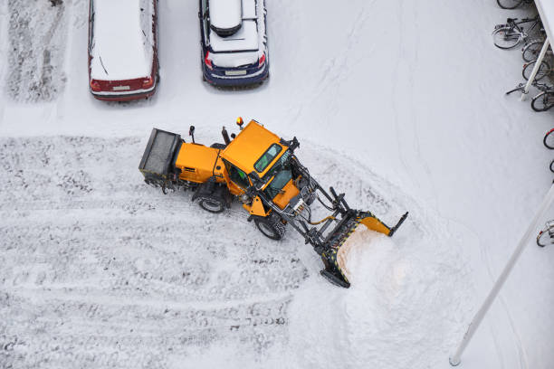 Tractor cleans a street after heavy snow. Tractor cleans a street after heavy snow. Top-down view to the street and tractor. A lot of pure white snow. snow plow stock pictures, royalty-free photos & images