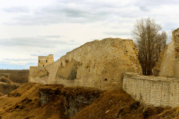 The panorama of the medieval fortress was made on a cloudy spring day. Izborsk, Pskov Region, Russia.