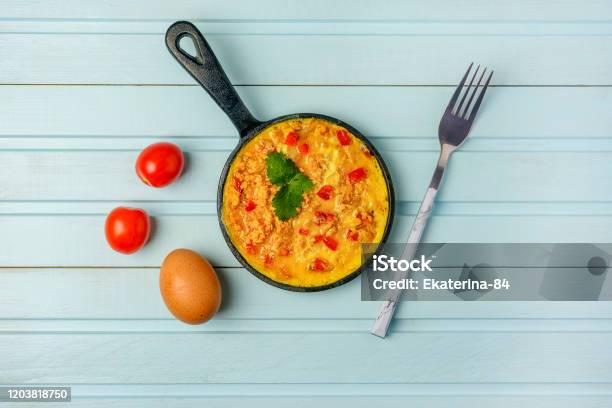 Freshly Made Omelet Turkish National Recipe Menemen With Eggs Bell Pepper And Tomatoes Photo On A Blue Background With Copy Space Stock Photo - Download Image Now