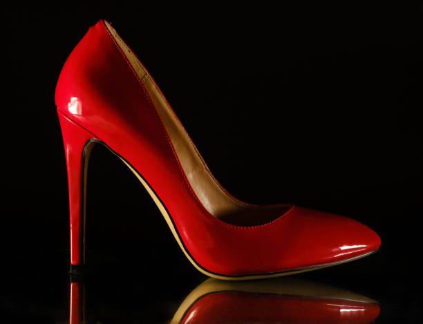 istock patent leather shiny female red stilettos on a black background 1203818983