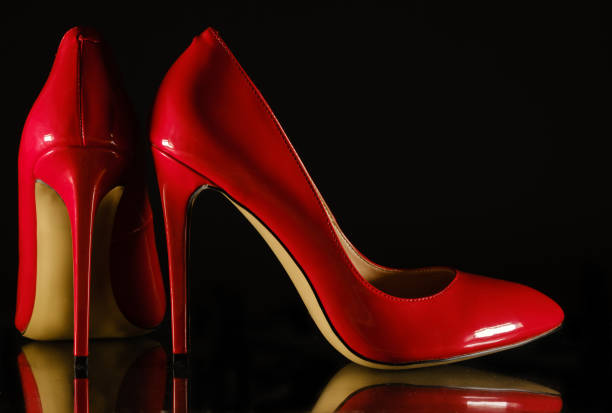 istock patent leather shiny female red stilettos on a black background 1203819028