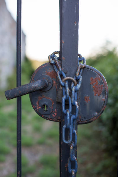 Closed antique iron gate with heavy safety chain