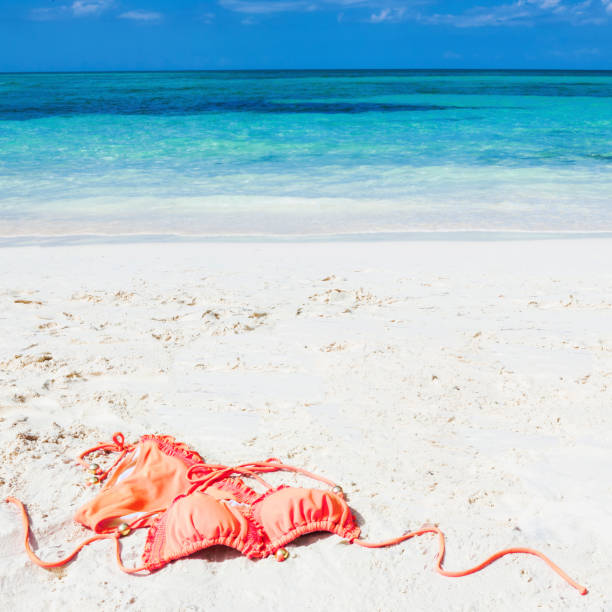 Orange Bikini on the Beach in the Bahamas, Caribbean Orange bikini on the beach at Grand Bahama Island in the Bahamas, Caribbean. swimwear bikini top bikini bikini bottom stock pictures, royalty-free photos & images