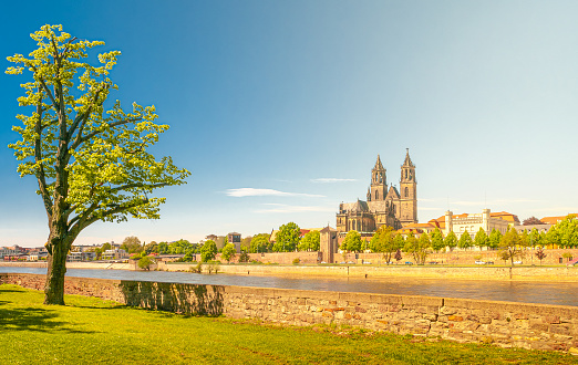 Panoramic view of Elbe, cathedral, old and modern town and a bench in Magdeburg at Spring