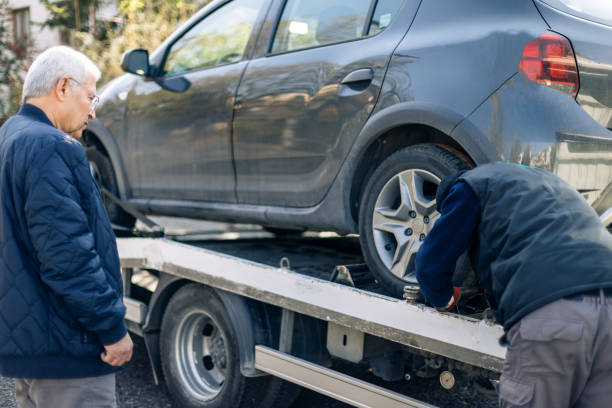 istock Car loaded onto tow truck 1203828019