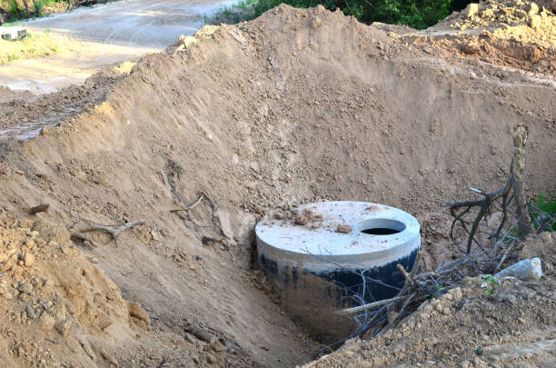 istock Installation of concrete sewer wells in the ground at the construction site 1203832571