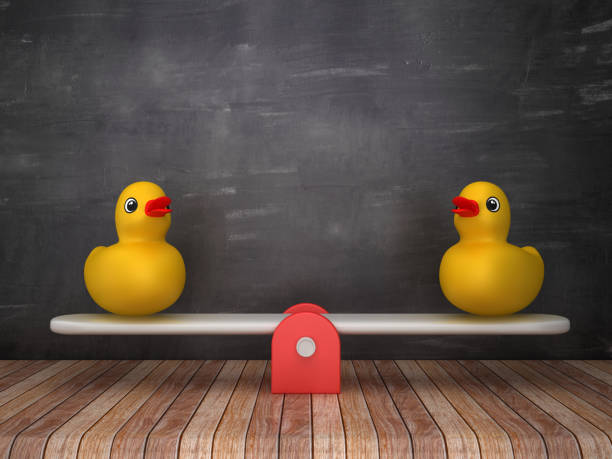 istock Seesaw Scale with Rubber Ducks on Wood Floor - Chalkboard Background - 3D Rendering 1203834189