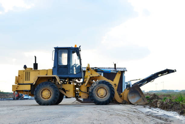 istock Wheel loader bulldozer with bucket on a construction site 1203836252