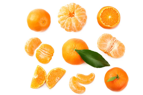 istock mandarin with slices and green leaf isolated on white background. top view 1203836469