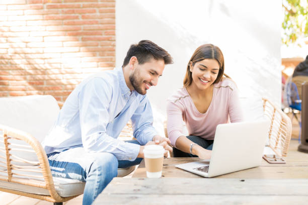 istock Happy Couple Is Using Laptop At Cafe 1203839564