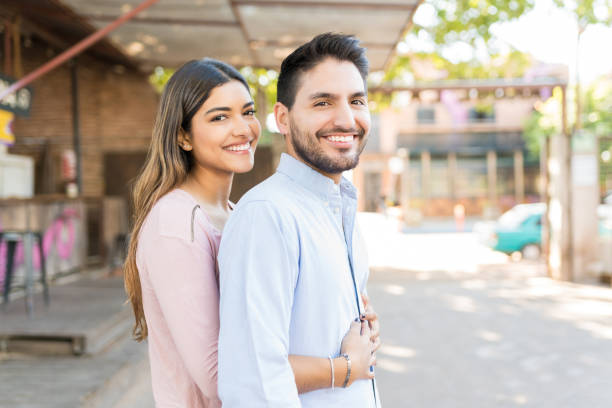 istock Happy Latin Couple Standing Outside Cafe 1203840455